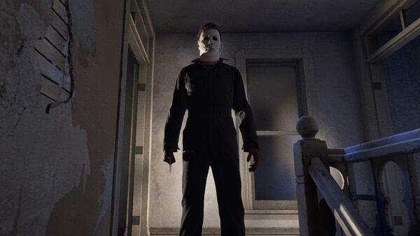 Screenshot from "Halloween: The Game" showing a masked character holding a knife, standing ominously at the top of a staircase.