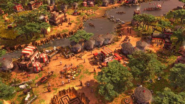 Screenshot from Age of Empires III: Definitive Edition - The African Royals showing a bustling African village near a river.