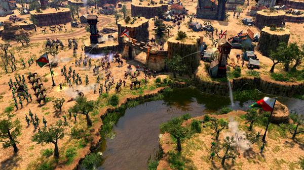 Screenshot from Age of Empires III: Definitive Edition - Mexico Civilization showing a large battle near a river in a desert landscape.