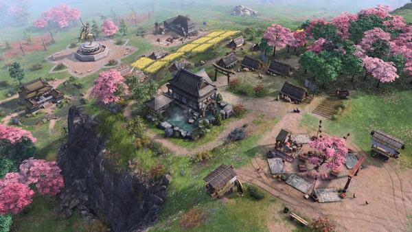 Screenshot of Age of Empires IV: Dynasties of the East showing a detailed village with cherry blossoms and farmland.