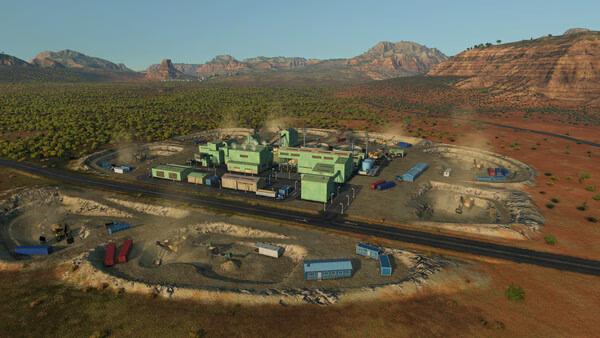 A Transport Fever 3 screenshot showing a mining facility in a desert landscape, with trucks and buildings surrounded by rugged terrain.