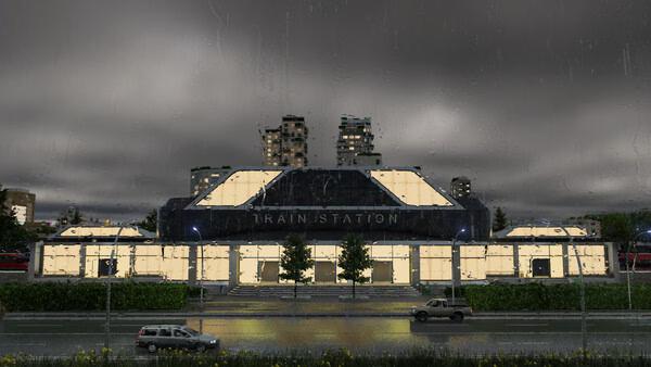 A Transport Fever 3 screenshot showing a brightly lit train station at night with cars passing in the foreground.