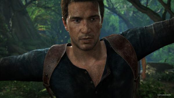 Screenshot from UNCHARTED: Legacy of Thieves Collection showing a character with arms outstretched in a lush jungle setting.