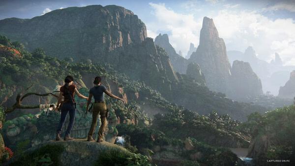 Screenshot from UNCHARTED: Legacy of Thieves Collection showing two characters overlooking a lush, mountainous landscape.
