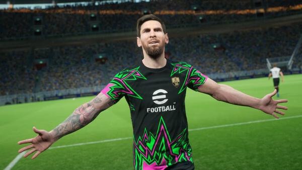 A player in a colorful jersey celebrates on the field in this eFootball™ game screenshot, with a stadium full of cheering fans.