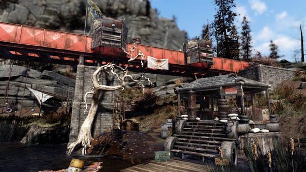 Fallout 76 screenshot of a red bridge, a shack with wooden stairs, and a twisted white tree in a rugged, outdoor landscape.