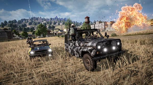 PUBG: BATTLEGROUNDS screenshot showing players driving camo and yellow vehicles through a field as an explosion erupts nearby.
