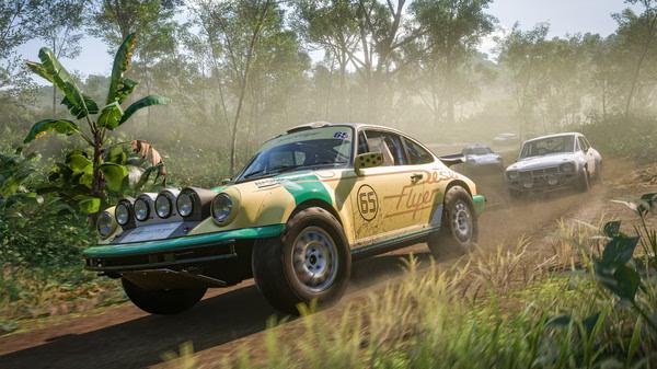 Forza Horizon 5 screenshot: A rally car races through a lush, tropical forest with other cars in the background.