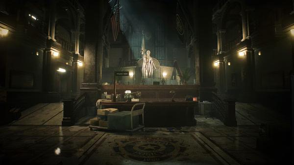 Resident Evil 2 screenshot: A dimly lit police station lobby with an elaborate statue at its center, surrounded by flags and office furniture.
