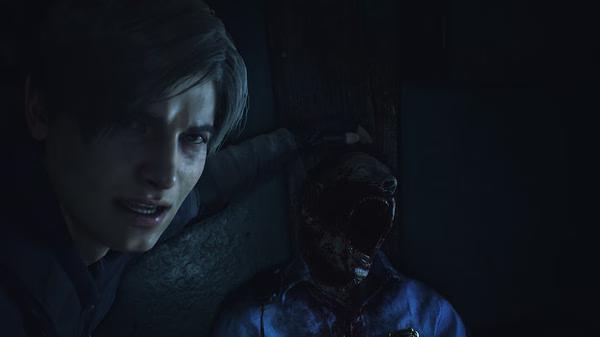 Resident Evil 2 screenshot: A character holds a weapon near a bloodied zombie wearing a torn police uniform in a dark setting.