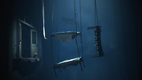 Little Nightmares II screenshot: A small figure in a yellow coat stands on a ledge, facing suspended platforms in a dimly lit room.