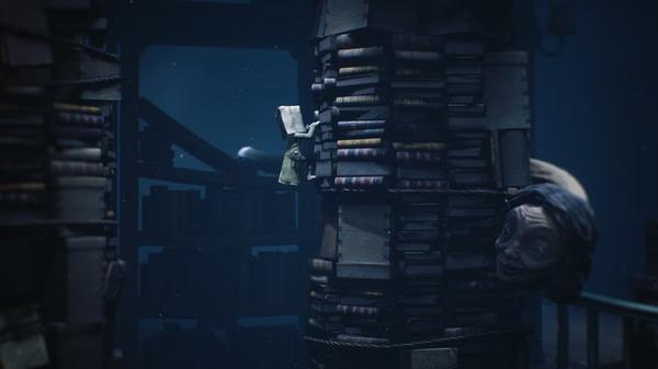 Screenshot from Little Nightmares II featuring a small character climbing a towering stack of books in a dark library setting.