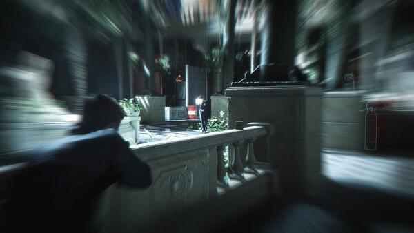 Screenshot from 007 First Light showing a character in stealth mode, crouching behind a stone railing in a dimly lit area.