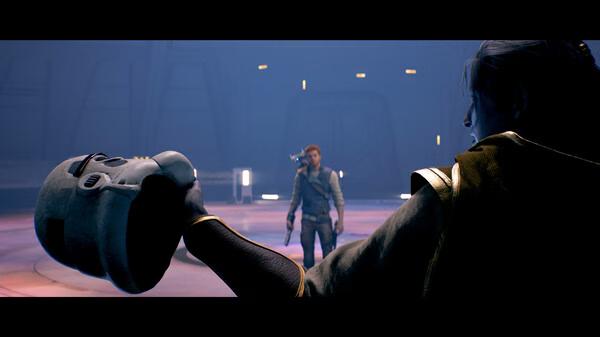 A screenshot from STAR WARS Jedi: Survivor™ shows a character holding a Stormtrooper helmet as another stands armed in the background.
