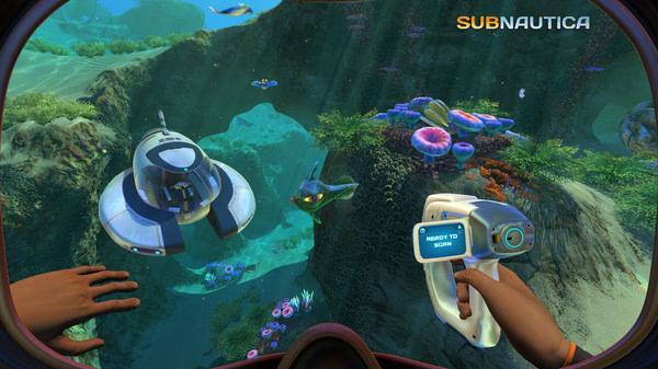 Subnautica screenshot: Player holds a scanner in an underwater scene with vibrant corals, a small submarine, and a fish.