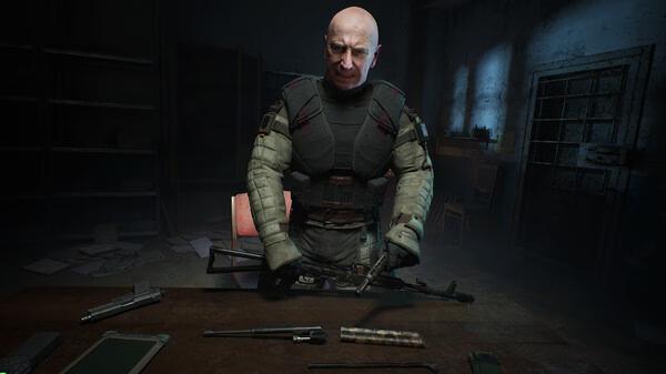 Screenshot from S.T.A.L.K.E.R. 2: Heart of Chornobyl showing an armored character assembling a weapon in a dimly lit room.