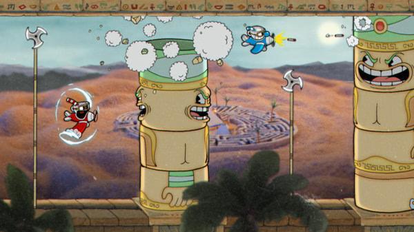 Screenshot from Cuphead showing animated characters battling flying stone faces in an ancient desert-themed landscape.