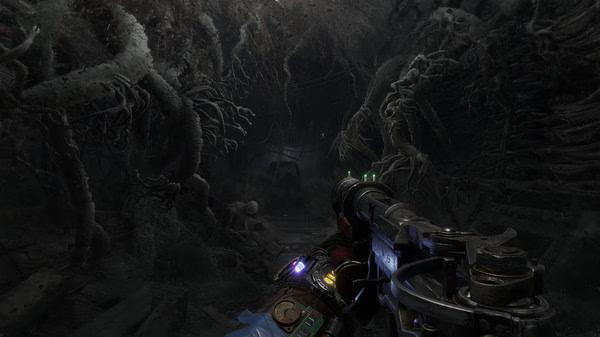 Metro Exodus screenshot: A player holds a weapon while exploring a dark, tangled underground tunnel with twisted roots.