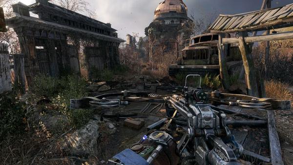 Screenshot from Metro Exodus showing a detailed crossbow in the foreground with a post-apocalyptic landscape and abandoned vehicles.