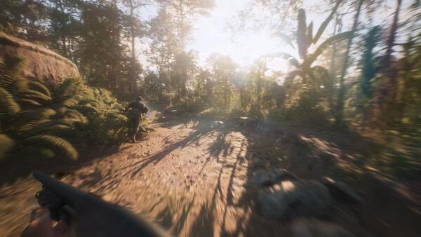 A Hell Let Loose: Vietnam screenshot showing a soldier running through a dense jungle with sunlight filtering through trees.
