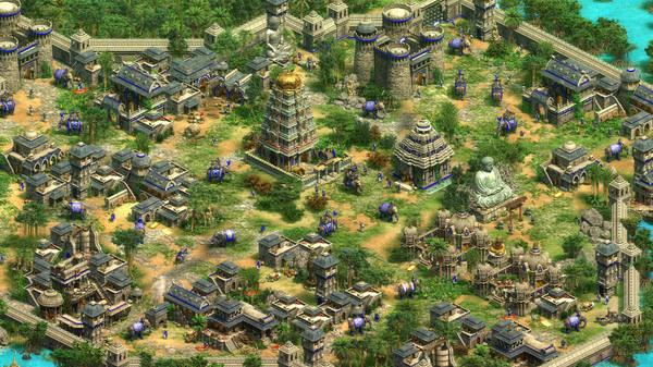 Age of Empires II screenshot showing a vibrant cityscape with temples, fortified structures, and elephants roaming the streets.
