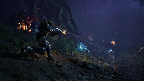 Halo: Campaign Evolved screenshot featuring a soldier firing at alien creatures in a dark, forested environment.