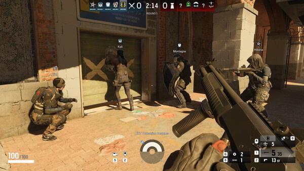 Screenshot from Tom Clancy's Rainbow Six Siege showing players breaching a barricaded door, with operators Kali and Montagne in action.