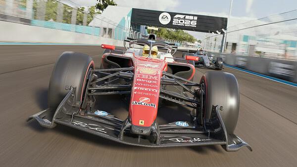 F1 25 screenshot: A red Formula 1 car races on a track with another car behind, under an EA Sports banner.