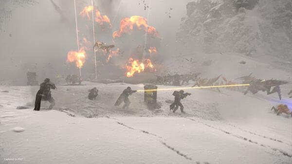 HELLDIVERS 2 screenshot: Players battle alien creatures in a snowy landscape with explosions and gunfire lighting up the scene.