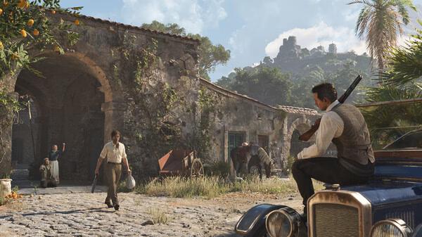 Screenshot from Mafia: The Old Country shows a man with a rifle sitting on a car in front of a rustic building.