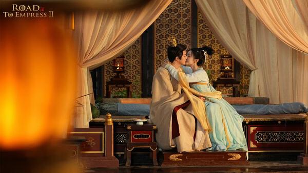 Screenshot from Road to Empress II showing two characters in traditional attire sharing a kiss in an ornate room.