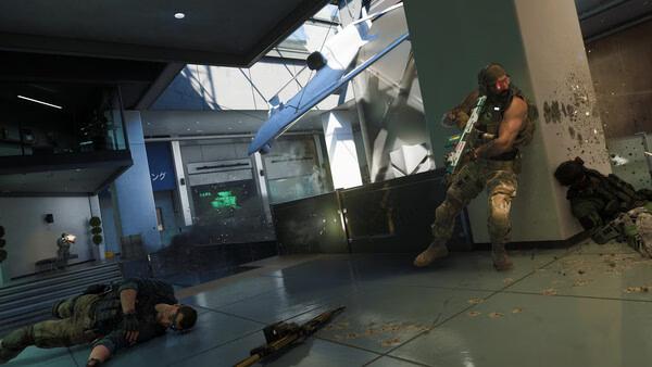Call of Duty: Black Ops 7 screenshot showing two soldiers in combat inside a modern building, with debris and a crashed drone visible.