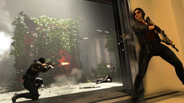 Screenshot from Call of Duty: Black Ops 7 showing soldiers in combat, one firing from cover inside a building.