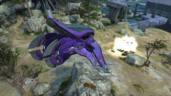 Screenshot from Halo: The Master Chief Collection showing a purple alien aircraft flying over a rocky landscape.