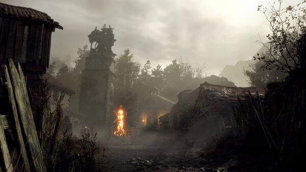 A Resident Evil 4 Remake screenshot showing a village with a fire, buildings, and a cloudy sky in the background.