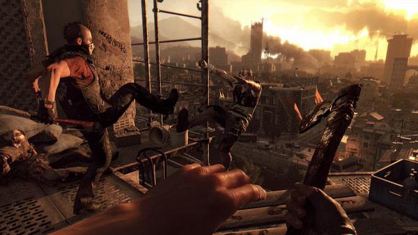 Dying Light screenshot: A dramatic rooftop battle at sunset with a survivor kicking a zombie while holding a weapon.