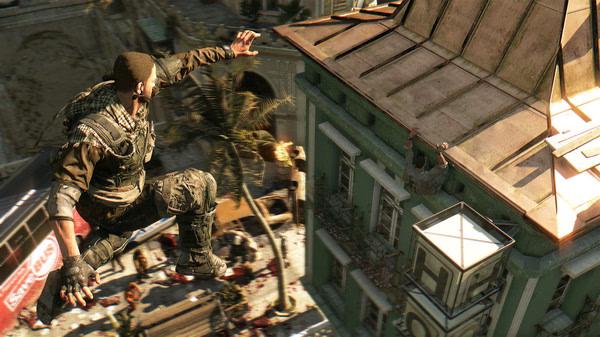A Dying Light screenshot showing a character mid-air, leaping towards a rooftop, with zombies and chaos visible on the streets below.