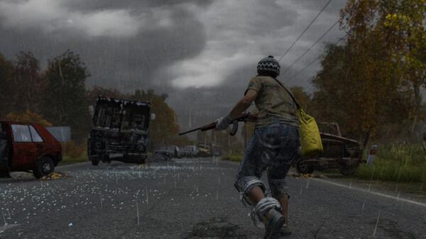 A DayZ screenshot showing a player with a rifle running down a rainy road, surrounded by abandoned vehicles and autumn trees.