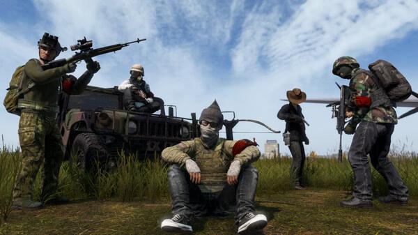 DayZ screenshot: Group of five armed players in military gear, some standing, one sitting, in grassy terrain with a vehicle behind them.