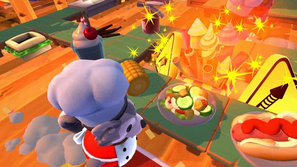 Overcooked! 2 screenshot: A chef character prepares dishes, including a salad and hotdog, amid a chaotic kitchen setting.