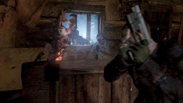 Resident Evil 6 screenshot: A player holding a gun takes cover inside a cabin as zombie-like creatures approach through a broken window.