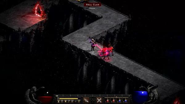 A Diablo II: Resurrected screenshot shows a character battling a Hell Clan demon on a dark, narrow stone bridge.