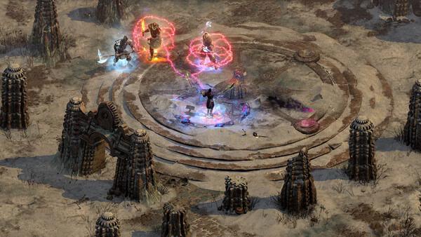 Diablo II: Resurrected screenshot showing four characters battling in a circular arena surrounded by stone structures.