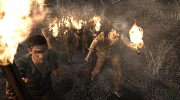 Resident Evil 4 (2005) screenshot: A group of villagers holding torches advance on a dark, forested path.