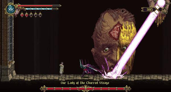Blasphemous screenshot: A player battles Our Lady of the Charred Visage, a giant face emitting a glowing beam.