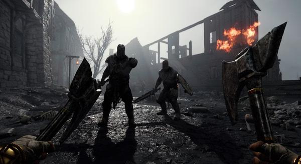 A Warhammer: Vermintide 2 screenshot showing two armored enemies approaching in a ruined, fire-lit village as axes are wielded in view.