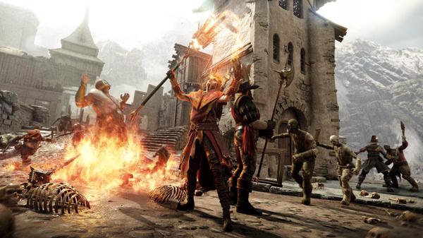 Warhammer: Vermintide 2 screenshot showing heroes battling Skaven and Chaos enemies in a fiery medieval village setting.