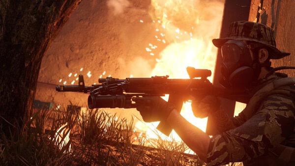 Insurgency: Sandstorm screenshot shows a soldier in camouflage gear and gas mask aiming a rifle amidst fiery explosions.
