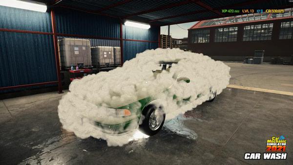 A Car Mechanic Simulator 2021 screenshot showing a green car covered in soap foam at a car wash inside a garage.