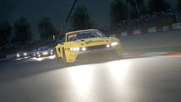 A nighttime race in Assetto Corsa Competizione; a yellow car leads on a curve with headlights shining. Screenshot of intense action.
